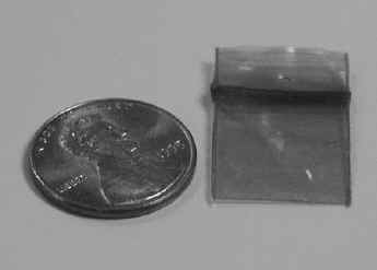 Photo of a penny and a small plastic bag. The bag is about the same size as the penny.