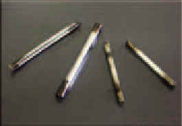 Photograph of pencil size glass and metal pipes.