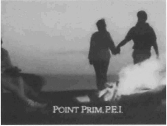 Exhibit L: A couple  walking  near a camp fire with the caption 'Point Prim, P.F.I.'