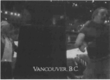 Exhibit N: Two men at an event with the caption 'Vancouver, BC'.