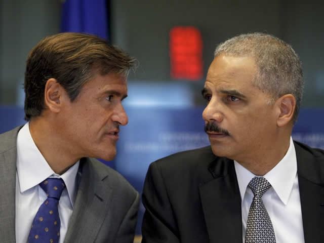 Juan Fernando Lopez Aguilar, Chairman of the European Parliament Committee on Civil Liberties, Justice and Home Affairs speaks with Attorney General Eric Holder during his appearance before the committee.