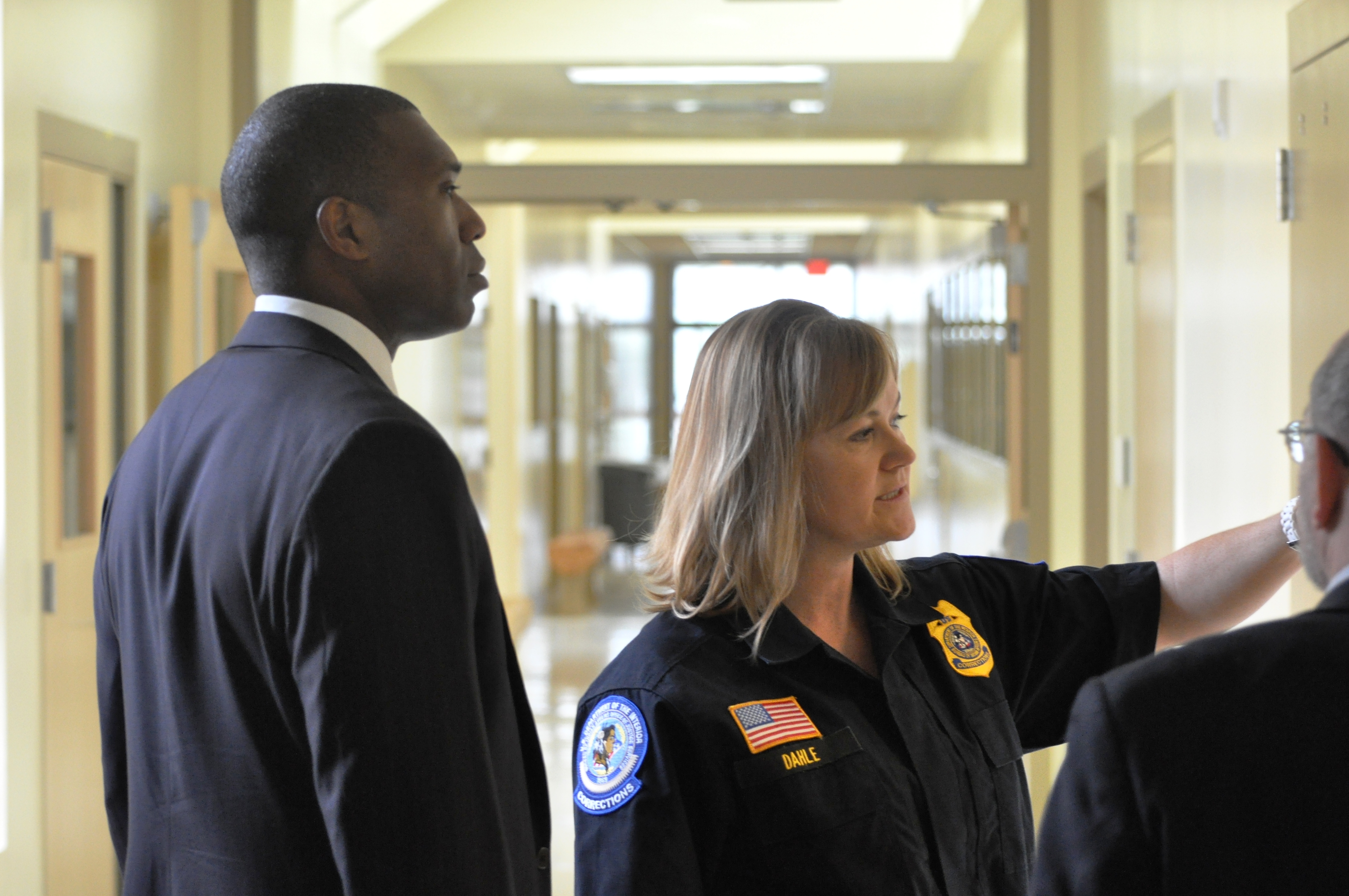Acting Associate Attorney General Tony West listens to Kim Dahle, Administrator of the Juvenile Detention Facility.