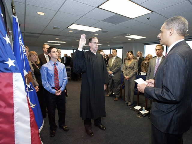 The Attorney General administers the oath of office.