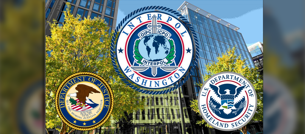 Photo of Constellation building 2 with seal of Justice, INTERPOL Washington, and Homeland Security