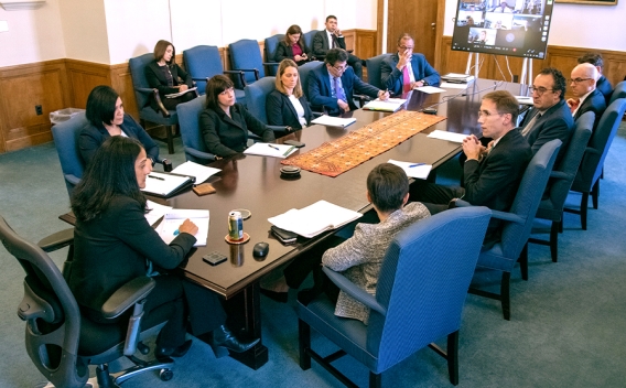 Representatives from many divisions within the Department of Justice sit around a table in the Associate Attorney General’s conference room to discuss reproductive rights.