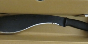 A picture displaying a machete with a black handle and curved blade.