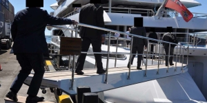 law enforcement boarding a yacht