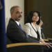 Attorney General Holder sitting next to Assistant Attorney General Moreno at the ceremony