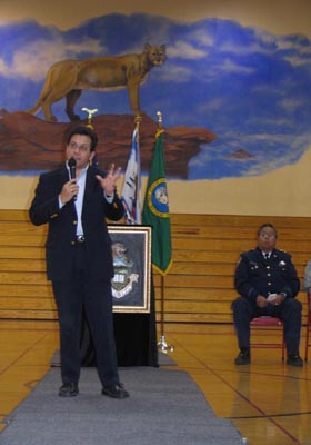 Attorney General Gonzales speaks to students at White Swan High School as Yakama Police Chief Davis Washines listens
