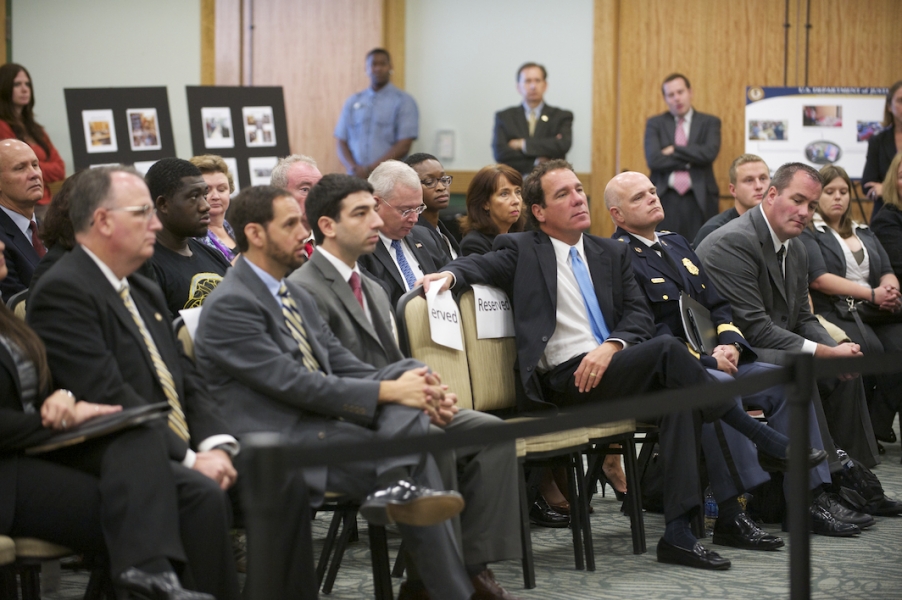 A crowd at Towson University listens as Attorney General Eric Holder, Deputy Attorney General James M. Cole, and U.S. Attorney for the District of Maryland Rod J. Rosenstein discuss increased efforts for the protection of intellectual property. A crowd listens as AG Holder, DAG Cole and US Attorney Rosentein discuss efforts for the protection of intellectual property.
