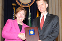 Acting Assistant Attorney General Sharis Pozen presents the 2011 Morrison Award to Jon Jacobs.