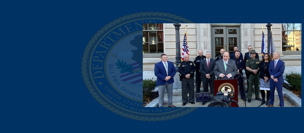 Photo of United States Attorney Will Thompson announcing the unsealing of a drug trafficking indictment against Derrell Cashawn Massey and numerous co-defendants, during a press conference outside the Sidney L. Christie Federal Building in Huntington, W.Va, on November 15, 2023. Standing behind Thompson are numerous law enforcement partners and the case’s prosecution team.