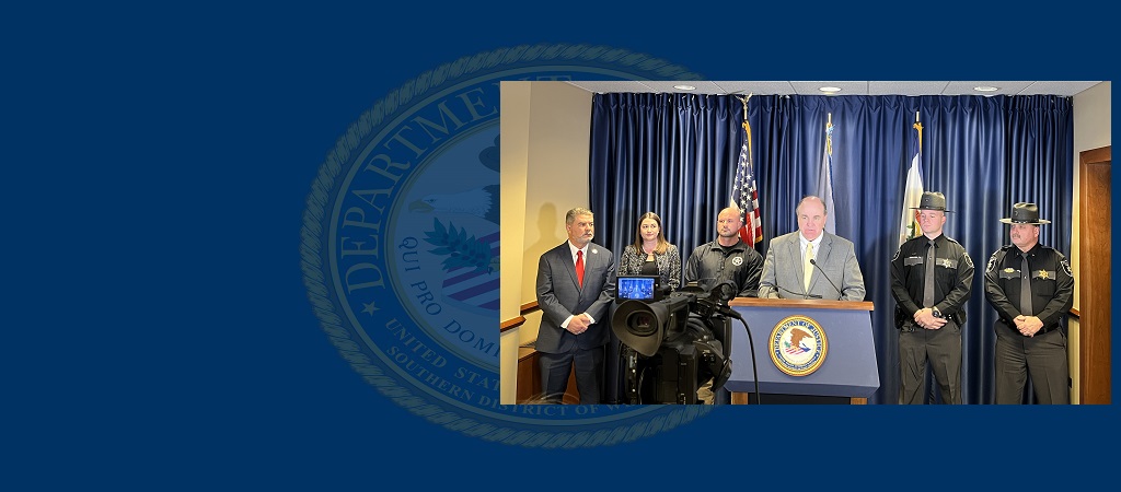 Photo of U.S. Attorney Will Thompson at the podium and flanked by other participants during a January 21, 2025, press conference announcing the capture of sex trafficking fugitive Tiwan Robert Bailey.