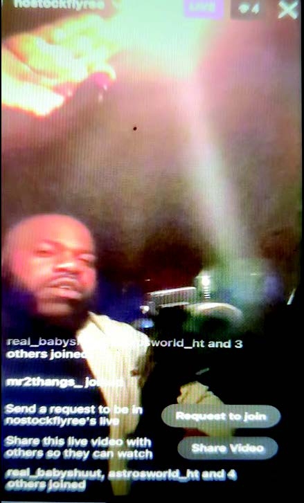 Screenshot showing an individual brandishing a firearm