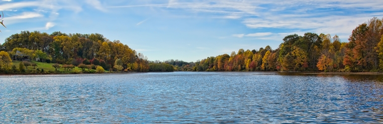Scenic view  of a river flanked by trees on a sunny day.  Courtesy of Jeff Bank (DOJ/ENRD/EO)