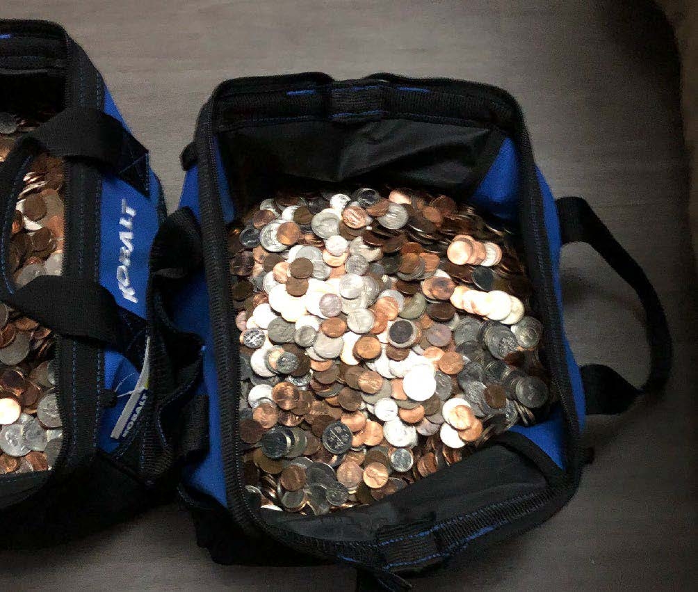 Stolen coins on display inside open tool bags.