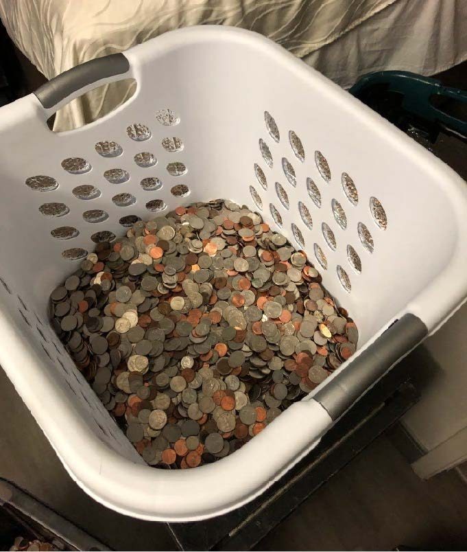 Stolen coins on display inside laundry basket.