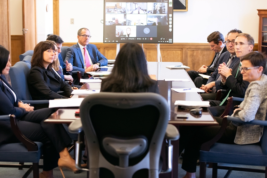 Representatives from many divisions within the Department of Justice sit around a table in the Associate Attorney General’s conference room to discuss reproductive rights.