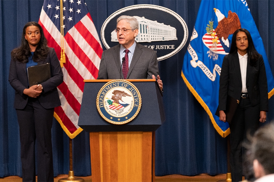 Attorney General Merrick B. Garland delivers remarks from a podium bearing The Department of Justice seal.