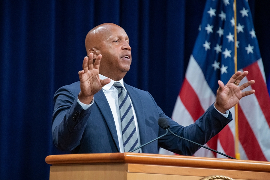 Equal Justice Initiative Executive Director Bryan Stevenson delivers remarks from a podium in the Great Hall at the Department of Justice.