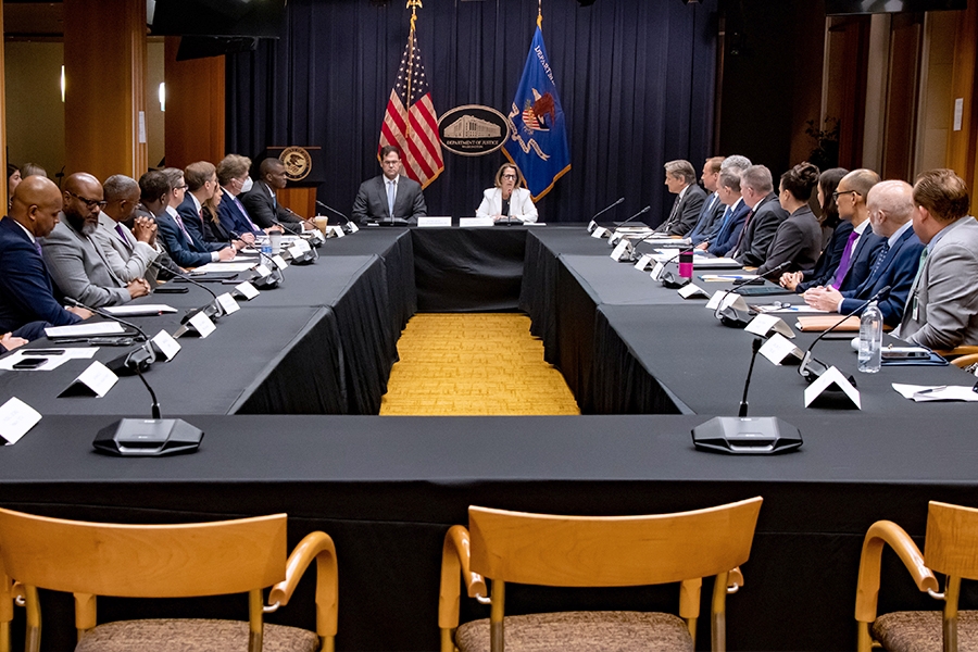 Deputy Attorney General Lisa O. Monaco (center right) leads with opening remarks at a roundtable meeting of senior Justice Department officials in the Department of Justice in Washington, D.C.