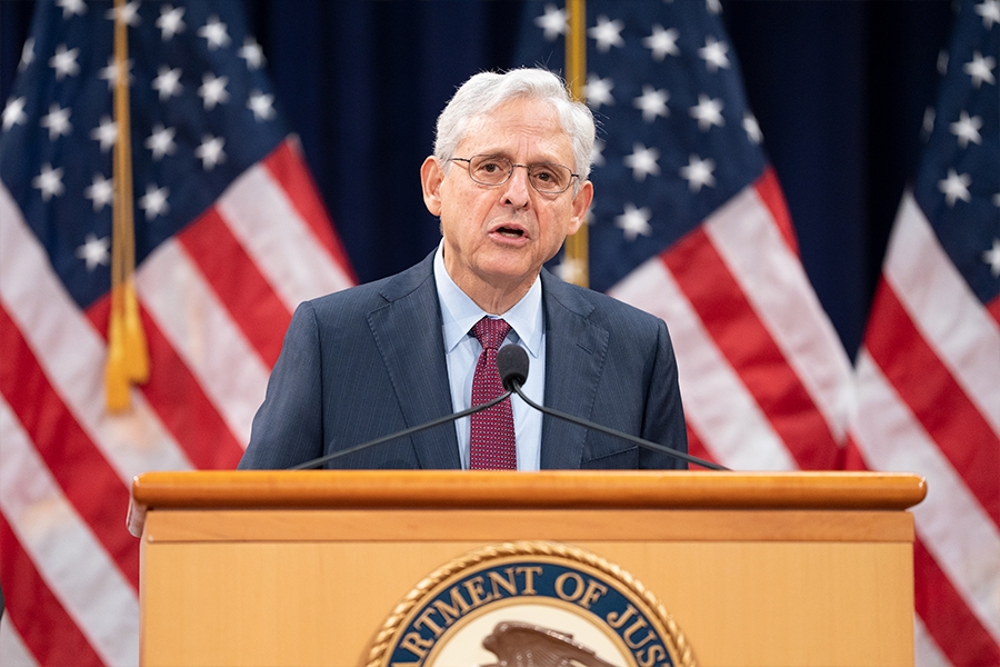 Attorney General Merrick B. Garland delivers remarks from a podium in the Great Hall at the Department of Justice.