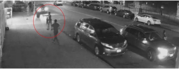 Still image from surveillance footage showing the defendant brandishing a firearm