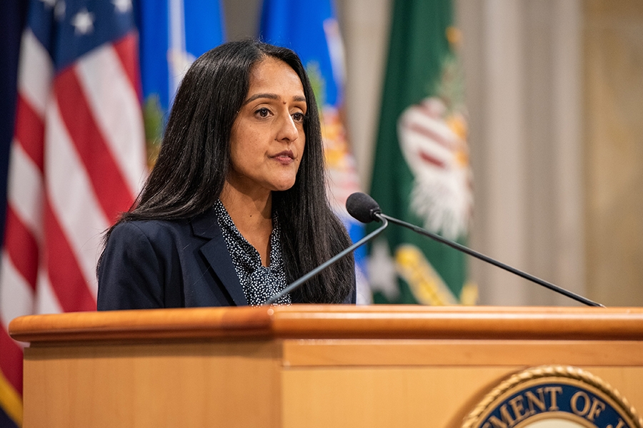 Associate Attorney General Vanita Gupta delivers remarks from a podium in the Great Hall at the Department of Justice