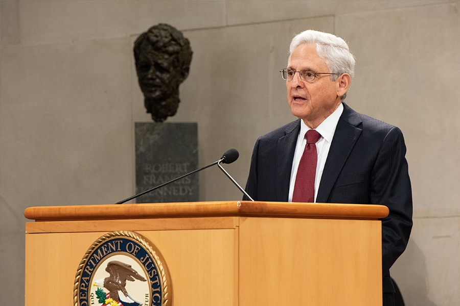 Attorney General Merrick B. Garland delivers remarks from a podium in the Great Hall at the Department of Justice