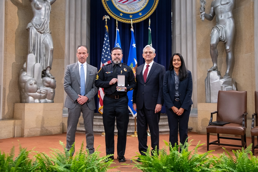 COPS Director Hugh T. Clements Jr., Attorney General Merrick B. Garland, and Associate Attorney General Vanita Gupta pose for photos with COPS award recipients