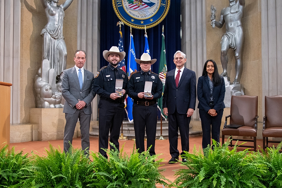 COPS Director Hugh T. Clements Jr., Attorney General Merrick B. Garland, and Associate Attorney General Vanita Gupta pose for photos with COPS award recipients