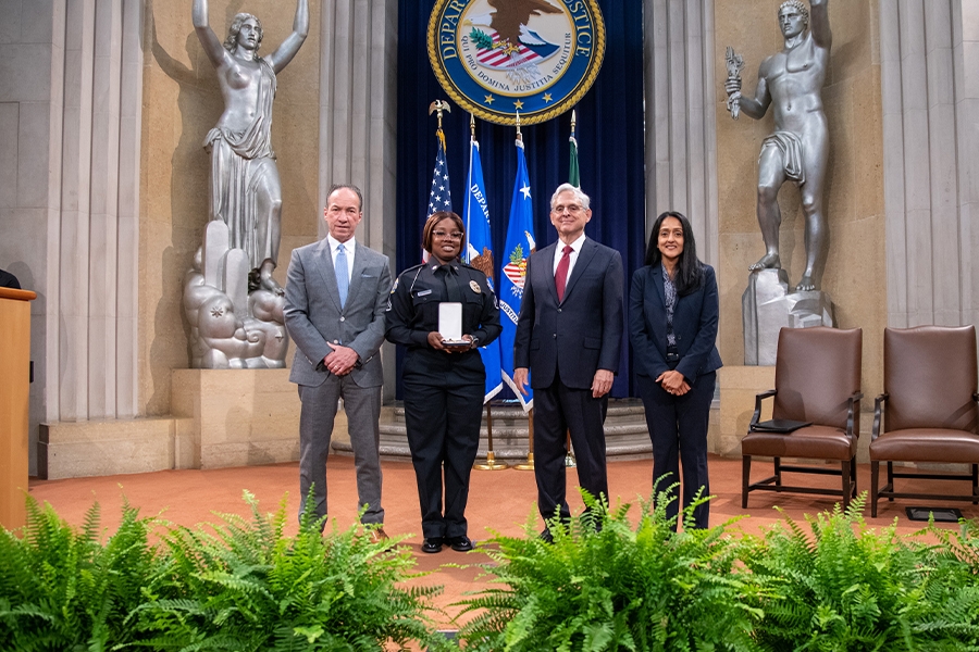 COPS Director Hugh T. Clements Jr., Attorney General Merrick B. Garland, and Associate Attorney General Vanita Gupta pose for photos with COPS award recipients