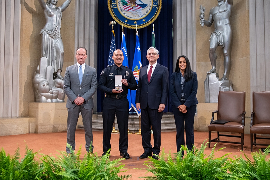 COPS Director Hugh T. Clements Jr., Attorney General Merrick B. Garland, and Associate Attorney General Vanita Gupta pose for photos with COPS award recipients