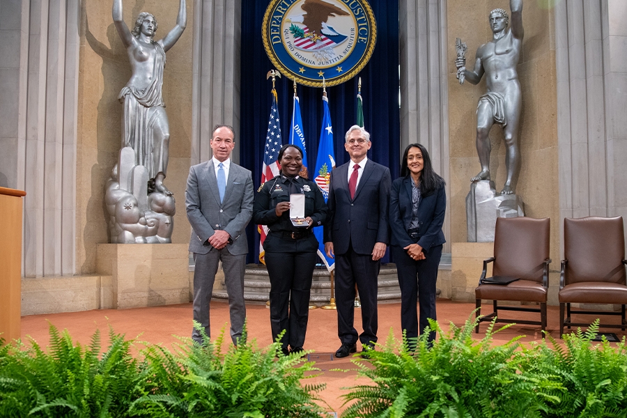 COPS Director Hugh T. Clements Jr., Attorney General Merrick B. Garland, and Associate Attorney General Vanita Gupta pose for photos with COPS award recipients