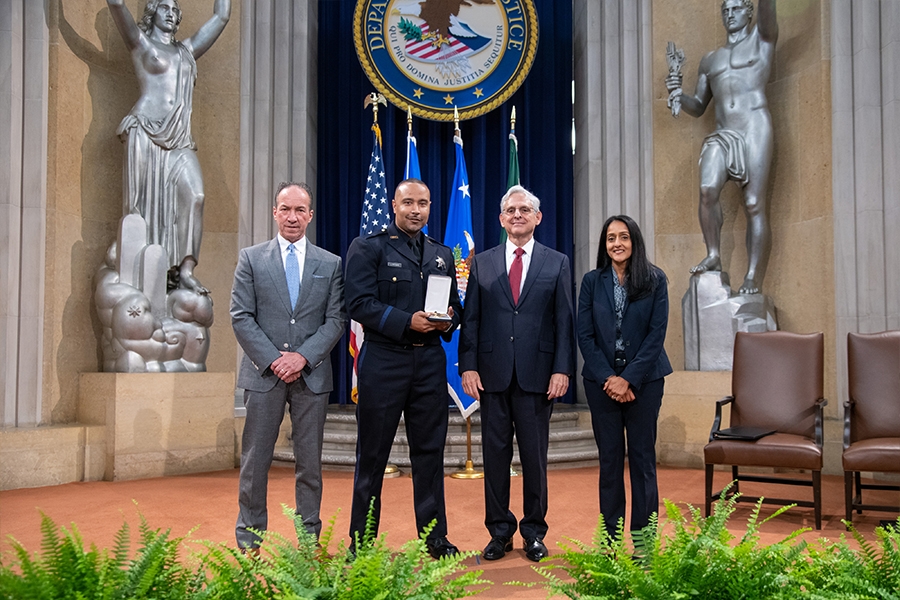 COPS Director Hugh T. Clements Jr., Attorney General Merrick B. Garland, and Associate Attorney General Vanita Gupta pose for photos with COPS award recipients