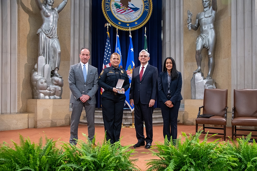 COPS Director Hugh T. Clements Jr., Attorney General Merrick B. Garland, and Associate Attorney General Vanita Gupta pose for photos with COPS award recipients