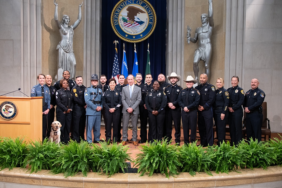 COPS Director Hugh T. Clements Jr. stands with distinguished policemen and policewomen in the Great Hall at the Department of Justice