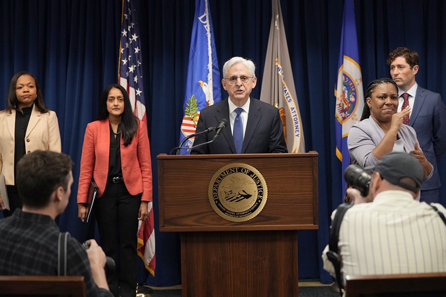 Attorney General Merrick B. Garland delivers remarks from a podium at the U.S. Attorney’s Office for the District of Minnesota.