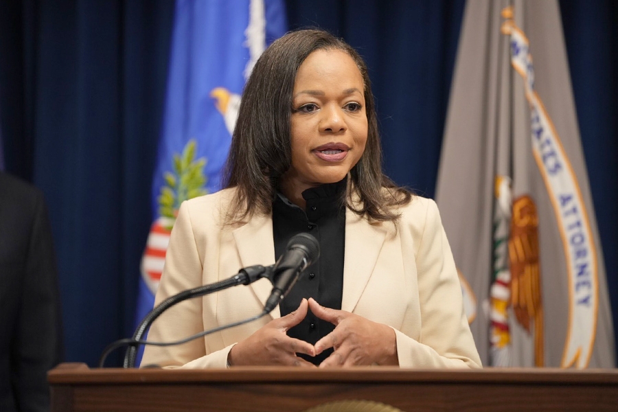 Assistant Attorney General for Civil Rights Kristen Clarke delivers remarks from a podium at the U.S. Attorney’s Office for the District of Minnesota.