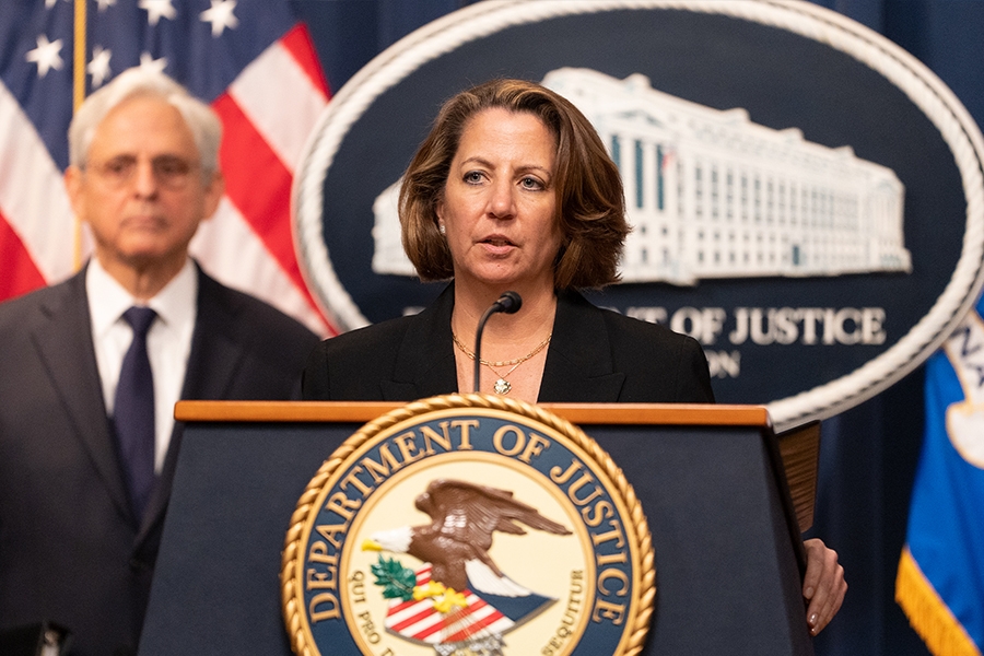 Deputy Attorney General Lisa O. Monaco delivers remarks from a podium at the Department of Justice.