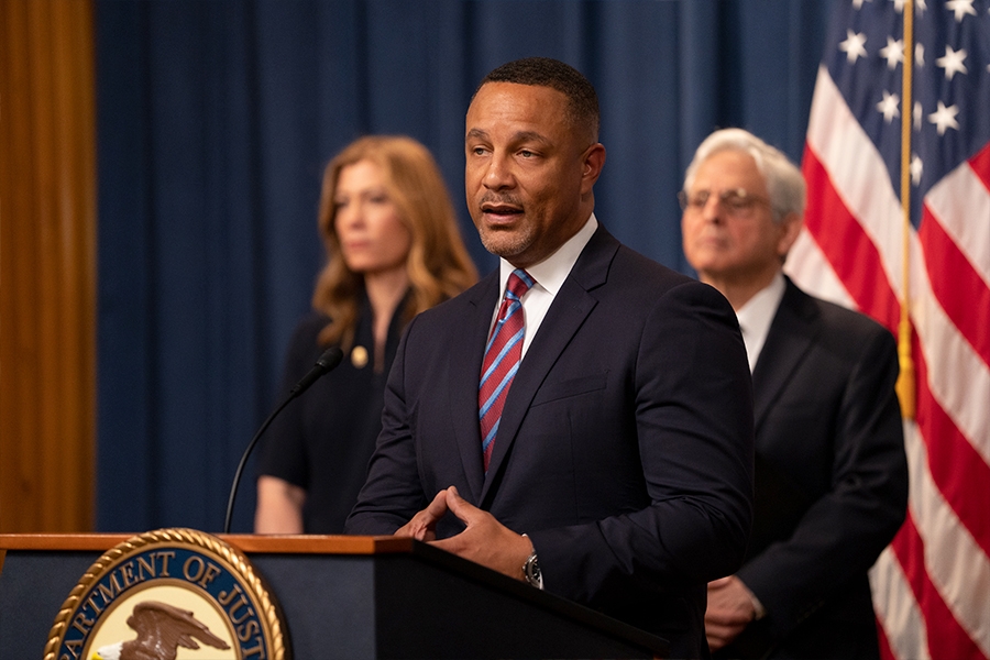 U.S Attorney Breon Peace for the Eastern District of New York delivers remarks from a podium at the Department of Justice.