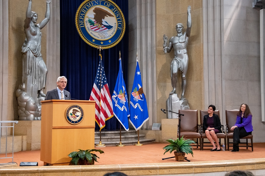 Attorney General Merrick B. Garland delivers remarks from a podium in the Great Hall at the Department of Justice