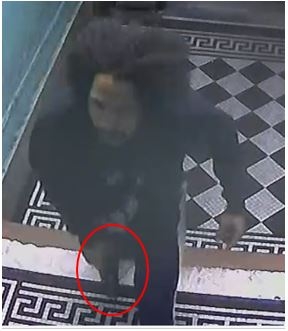 Still image showing the defendant holding a firearm