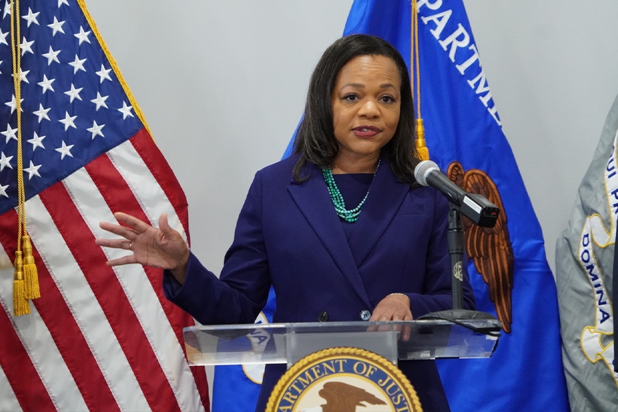 Assistant Attorney General for Civil Rights Kristen Clarke delivers remarks from a podium at the U.S. Attorney's Office for the Middle District of Florida