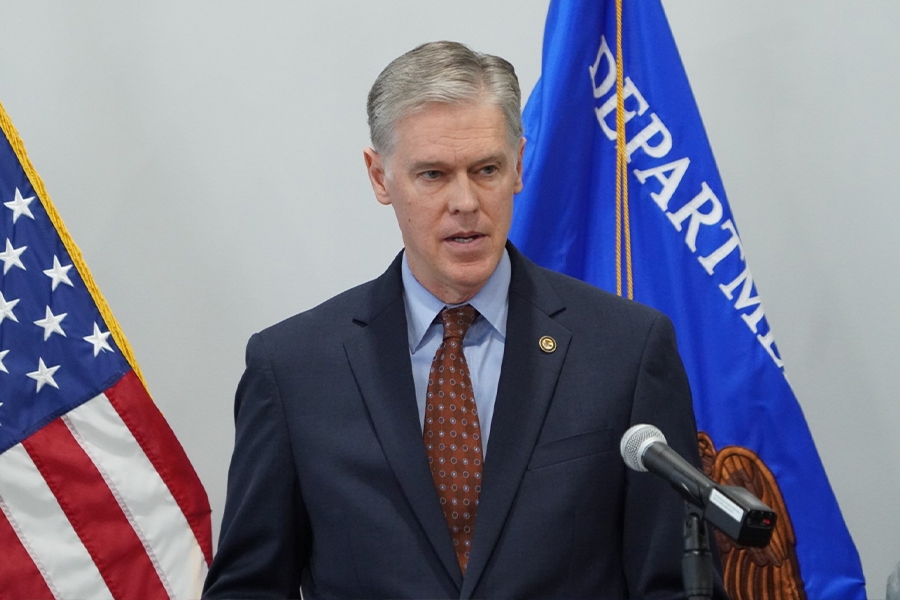 U.S. Attorney Roger B. Handberg delivers remarks from a podium at the U.S. Attorney's Office for the Middle District of Florida