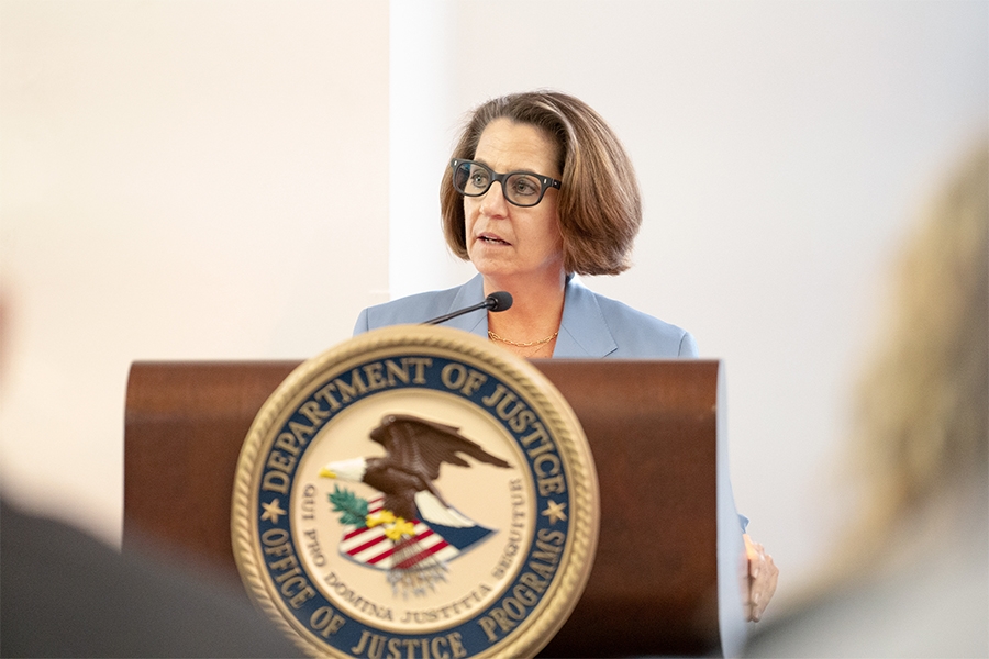 Deputy Attorney General Lisa O. Monaco delivers remarks from a podium at the Office of Justice Programs.