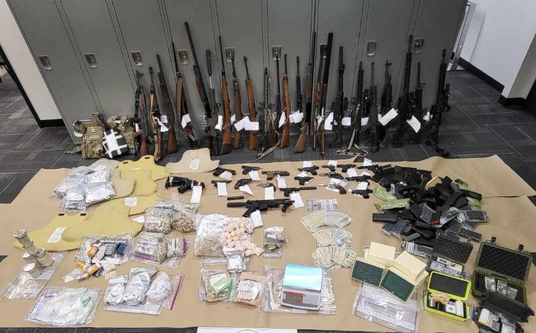 Full seizure of guns and drugs, drug processing materials, and cash