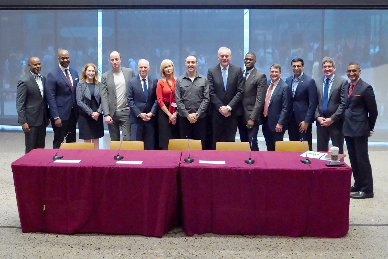 A group of 13 individuals standing together.