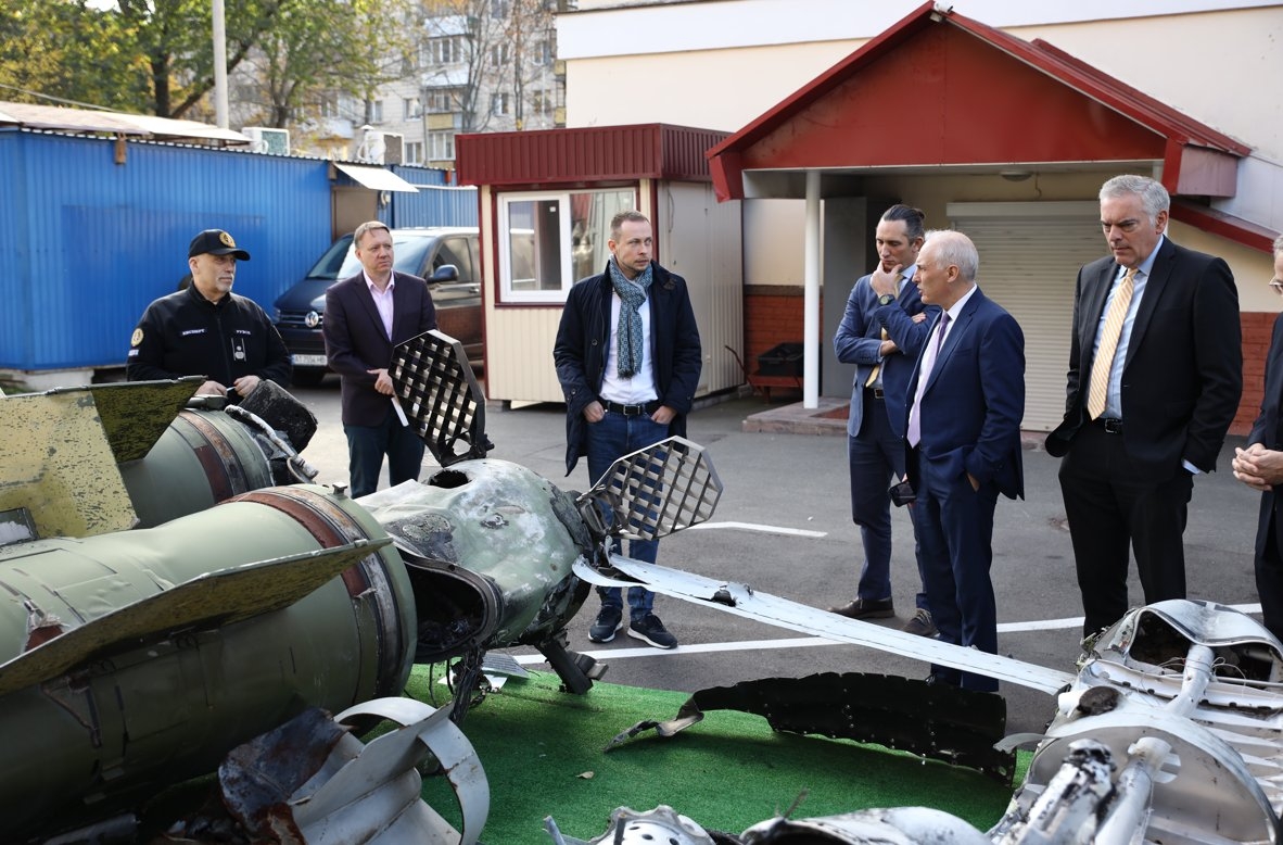 Assistant Attorney General Olsen and Assistant Secretary Axelrod view weapons recovered from the front lines in Ukraine, including ballistic missiles, air-guided missiles, and unmanned aerial vehicles, during their visit to Kyiv in November 2023.