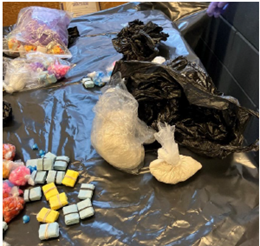 Photo of suspected narcotics and materials designed for use in packing narcotics for distribution